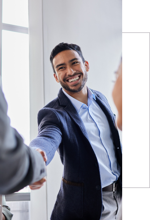 A man shakes hands with another man during a business meeting for Innovative Management Solutions.


